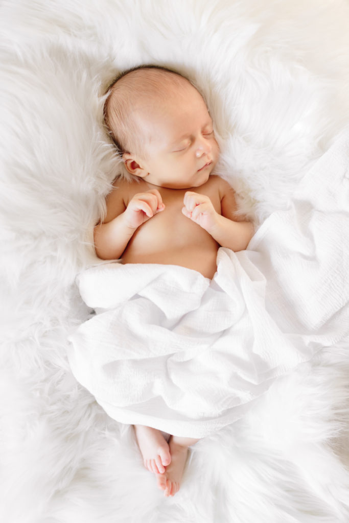 newborn photo on white backdrop